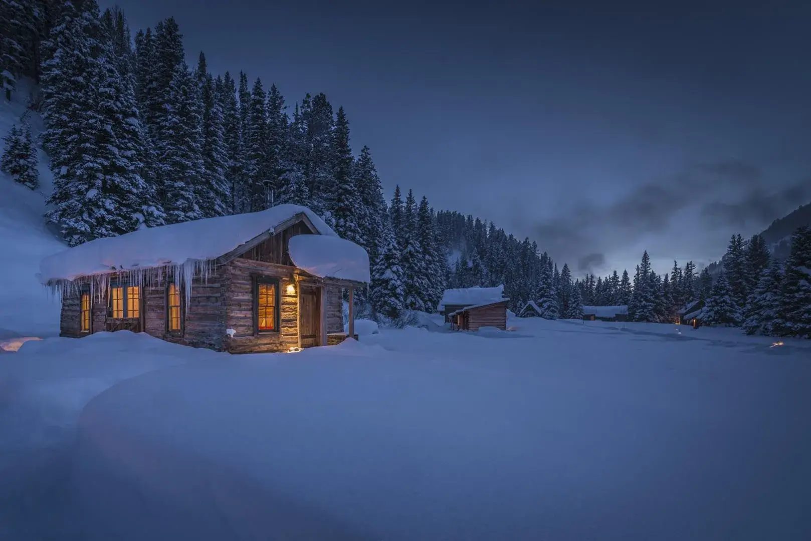 A remote, secluded cabin in a snowy forest.