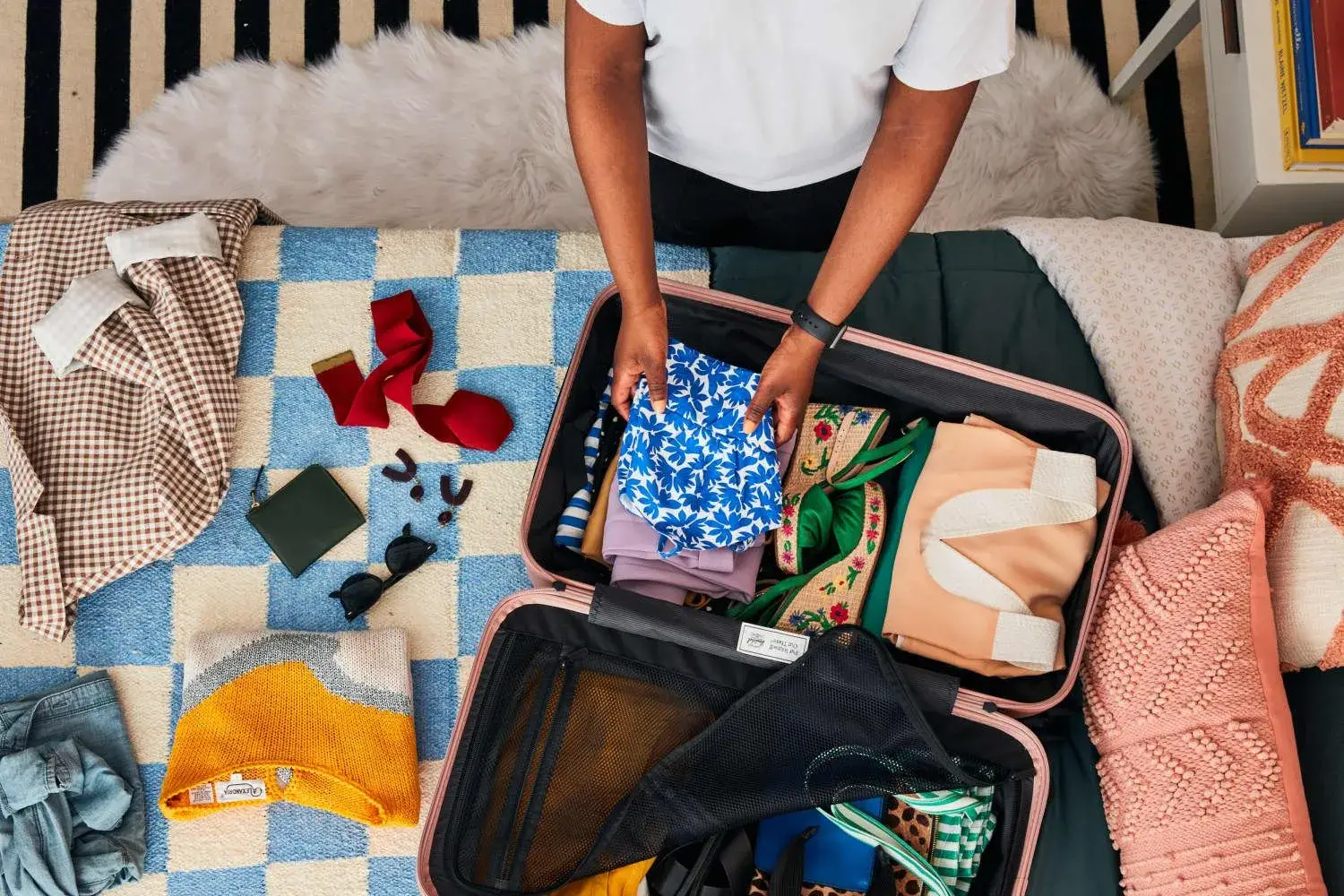 A person packing a suitcase efficiently.